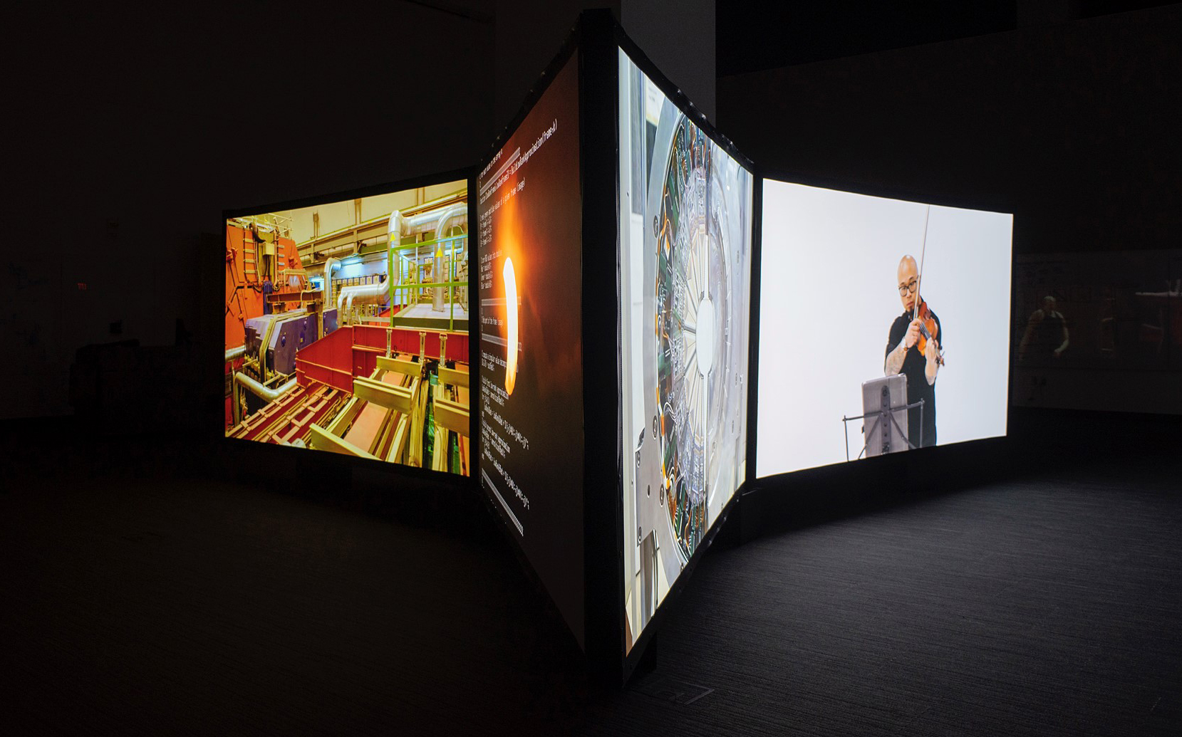 &lt;strong&gt;Figure 2.&lt;/strong&gt; Artist Janet Biggs, mathematician Agnieszka Międlar, and physicist Daniel Tapia Takaki debuted the Collective Entanglements exhibition at the University of Kansas’ Spencer Museum of Art in 2022. The experience included a six-channel video installation with sound, as well as interactive whiteboards for visitors. Photo by Ryan Waggoner © Spencer Museum of Art.